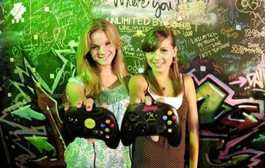 GameStop TV in store Retail Digital Signage featuring Branded Content over OTT appealing to Video Game culture and lifestyle featuring competitive professional video gamers Bonnie Xena Burton and Smiley